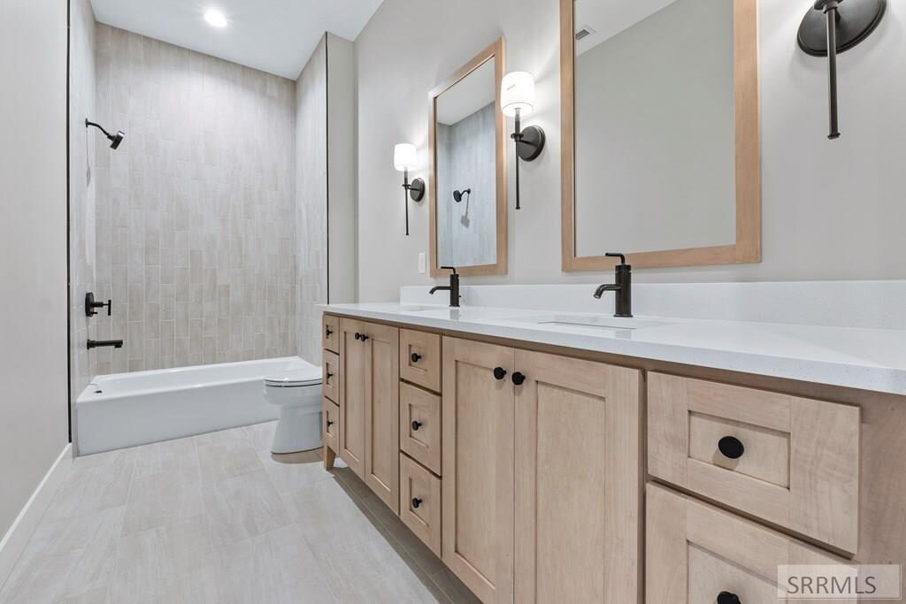 Secondary bathroom with dual vanity and tub