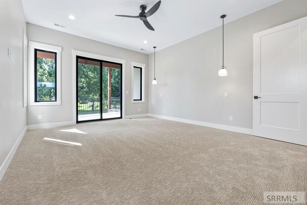 Primary bedroom with slider doors and views